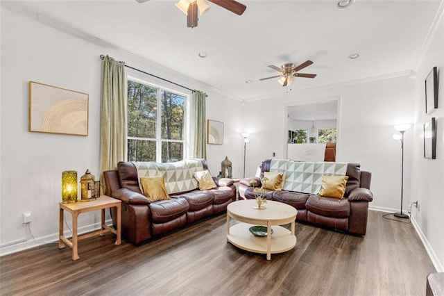 living room featuring a ceiling fan, wood finished floors, baseboards, and ornamental molding