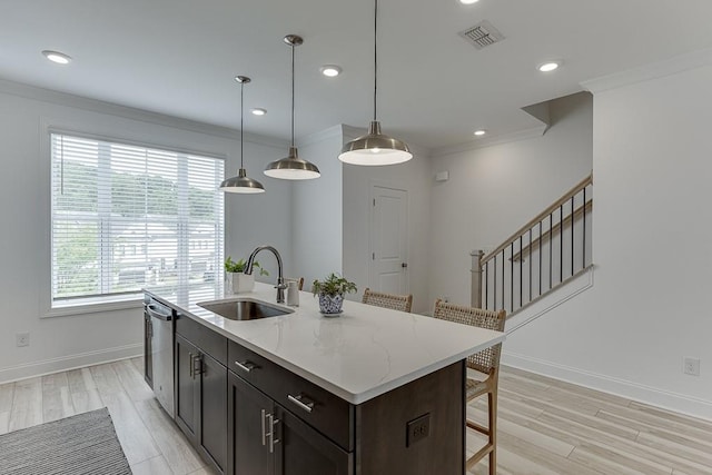 1117 Larkin Dr, Buford, GA 30518 - kitchen featuring a sink, stainless steel dishwasher, a kitchen bar, light wood-style flooring, and crown molding