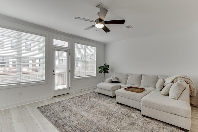 1117 Larkin Dr, Buford, GA 30518 - living room featuring ornamental molding, ceiling fan, baseboards, and wood finished floors