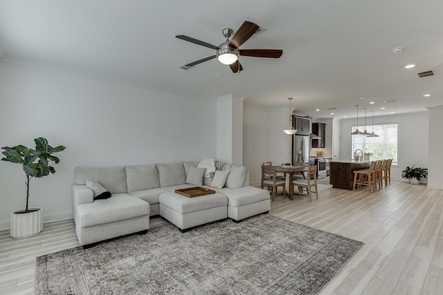 1117 Larkin Dr, Buford, GA 30518 - living area featuring a ceiling fan, light wood-type flooring, recessed lighting, baseboards, and crown molding