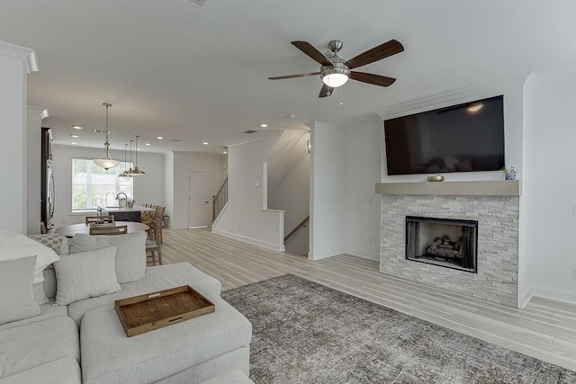 1117 Larkin Dr, Buford, GA 30518 - living area featuring ceiling fan, light wood finished floors, recessed lighting, a fireplace, and stairway