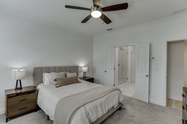 1117 Larkin Dr, Buford, GA 30518 - bedroom with crown molding, baseboards, ensuite bath, light colored carpet, and ceiling fan