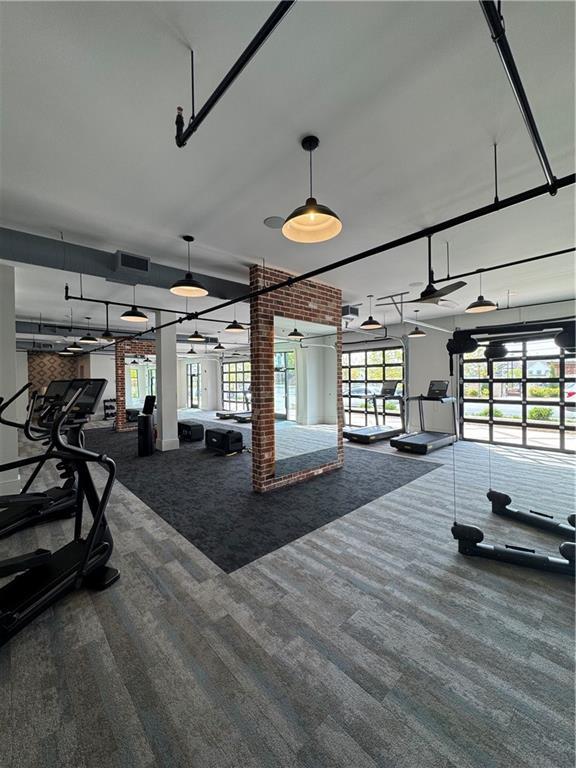 1117 Larkin Dr, Buford, GA 30518 - workout area featuring carpet, ornate columns, and brick wall