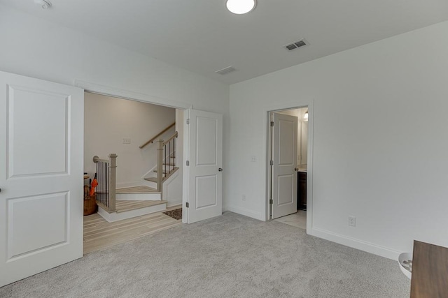 1117 Larkin Dr, Buford, GA 30518 - below grade area with light carpet, stairway, and baseboards
