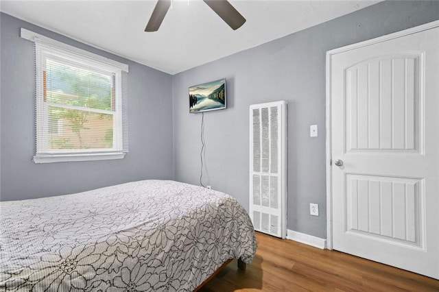 210 Estoria St SE, Atlanta, GA 30316 - bedroom with a heating unit, wood finished floors, baseboards, and ceiling fan