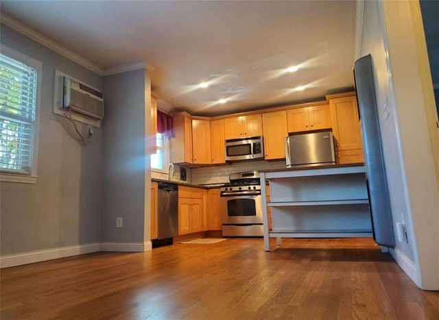 kitchen featuring baseboards, dark wood finished floors, appliances with stainless steel finishes, crown molding, and tasteful backsplash