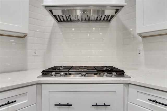 1105 Sterling Brooke Dr, Alpharetta, GA 30022 - kitchen with extractor fan, stainless steel gas stovetop, decorative backsplash, and white cabinetry