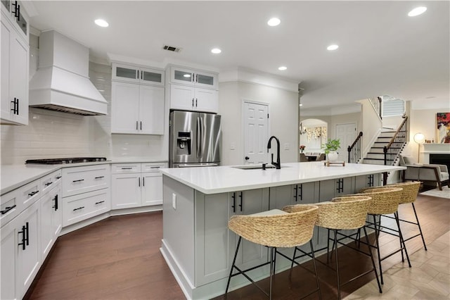 1105 Sterling Brooke Dr, Alpharetta, GA 30022 - kitchen with stainless steel refrigerator with ice dispenser, custom range hood, recessed lighting, crown molding, and light countertops