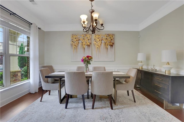 1105 Sterling Brooke Dr, Alpharetta, GA 30022 - dining space featuring a chandelier, ornamental molding, wood finished floors, and a wainscoted wall