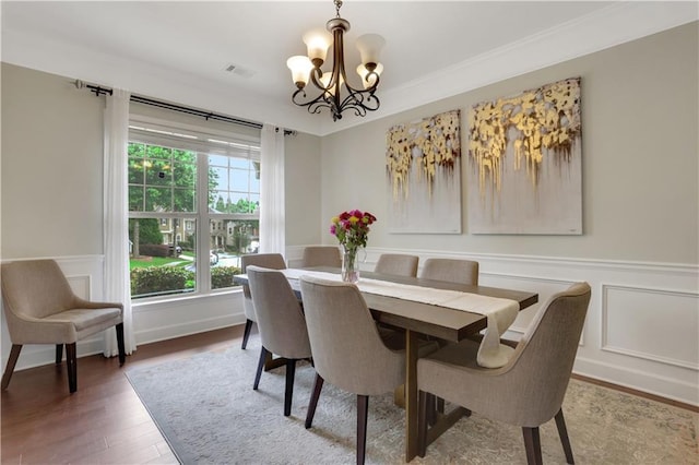 1105 Sterling Brooke Dr, Alpharetta, GA 30022 - dining space with a chandelier, wood finished floors, a wainscoted wall, a decorative wall, and crown molding