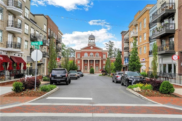 1105 Sterling Brooke Dr, Alpharetta, GA 30022 - view of asphalt road featuring traffic signs, sidewalks, curbs, and street lighting