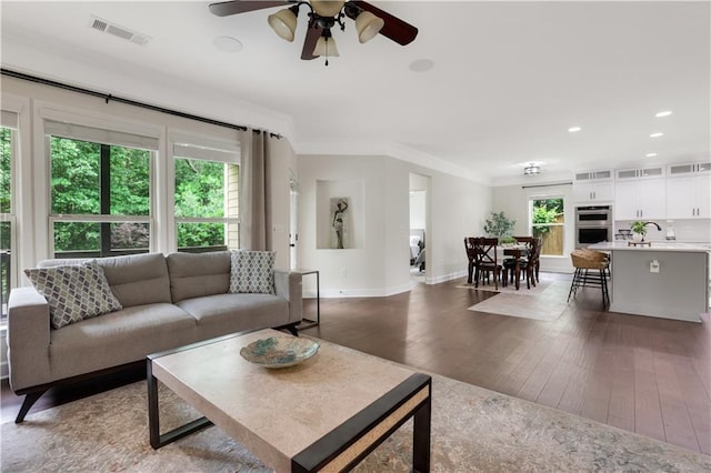 1105 Sterling Brooke Dr, Alpharetta, GA 30022 - living room featuring a ceiling fan, dark wood-style flooring, ornamental molding, and recessed lighting