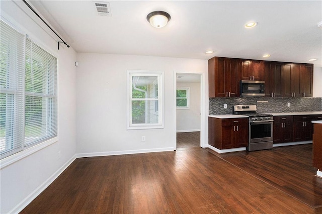 2308 Scotty Cir, Decatur, GA 30032 - kitchen with stainless steel appliances, light countertops, dark wood-type flooring, decorative backsplash, and baseboards