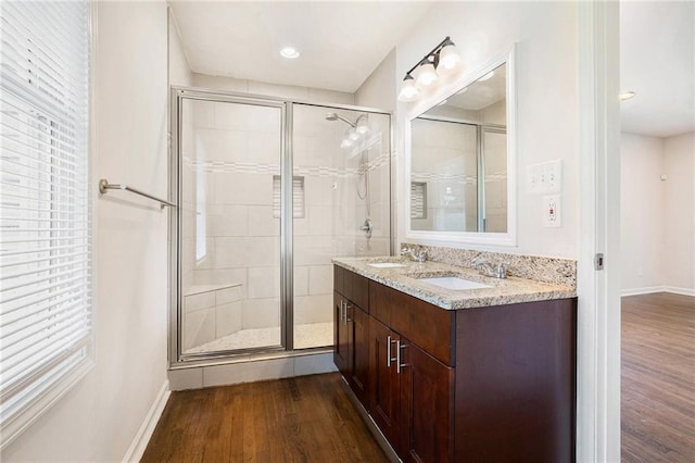 2308 Scotty Cir, Decatur, GA 30032 - bathroom with wood finished floors, a shower stall, baseboards, and double vanity