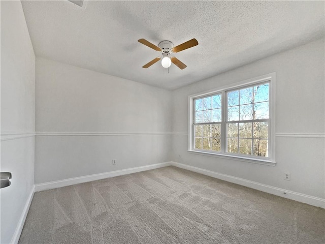 unfurnished room with ceiling fan, a textured ceiling, and carpet flooring