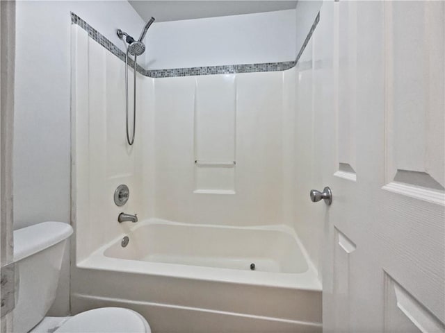 bathroom featuring shower / bathtub combination and toilet