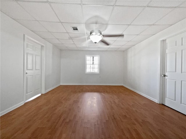 spare room with hardwood / wood-style floors, a paneled ceiling, and ceiling fan