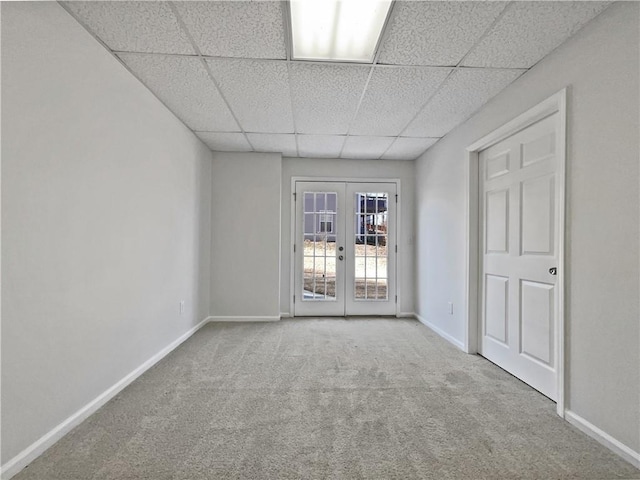 carpeted spare room with french doors and a paneled ceiling