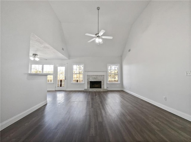 unfurnished living room with high vaulted ceiling, dark hardwood / wood-style floors, and ceiling fan