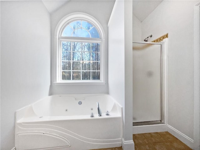 bathroom featuring tile patterned flooring, lofted ceiling, and shower with separate bathtub