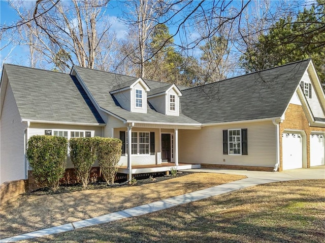 new england style home with a front yard and covered porch