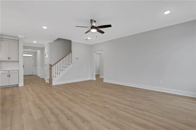 unfurnished living room with ceiling fan and light wood-type flooring