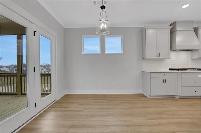 unfurnished dining area featuring plenty of natural light and light wood-type flooring