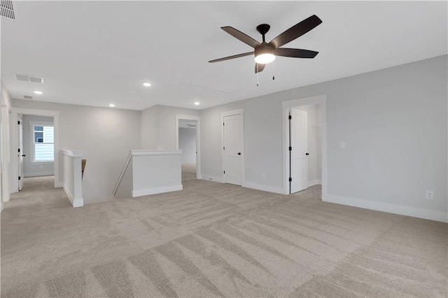 carpeted spare room with ceiling fan