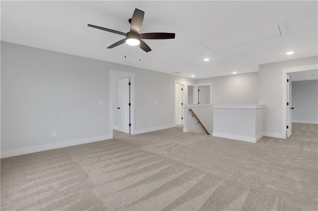 spare room with ceiling fan and light carpet