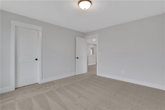 spare room with light colored carpet