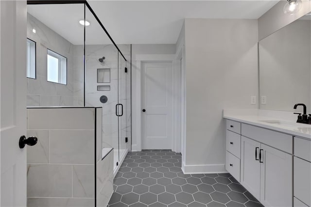 bathroom with tile patterned floors, vanity, and a shower with shower door