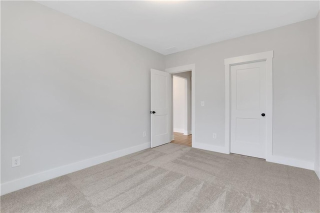 unfurnished bedroom featuring light carpet