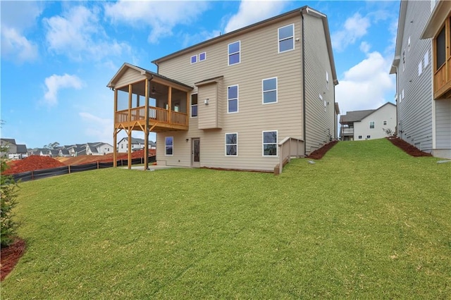 back of property featuring a sunroom and a yard