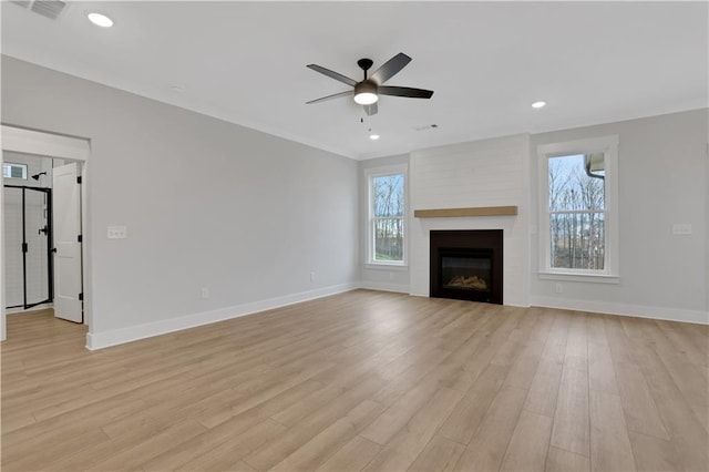 unfurnished living room with a large fireplace, ceiling fan, and light hardwood / wood-style flooring