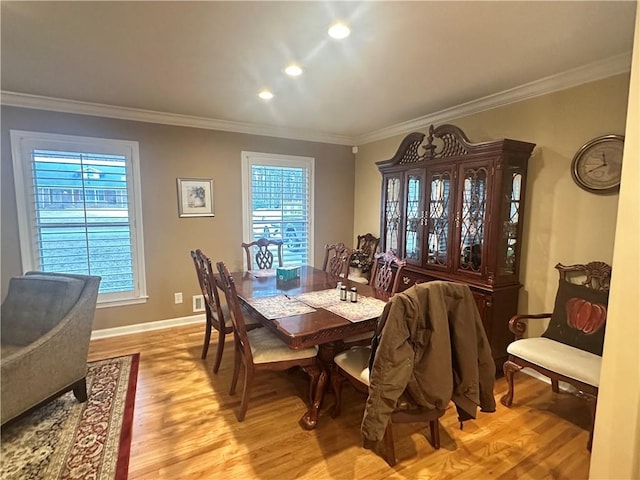 dining area featuring light hardwood / wood-style floors and ornamental molding