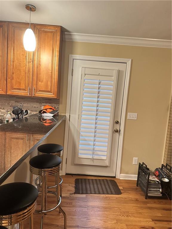 entryway featuring light hardwood / wood-style flooring and ornamental molding