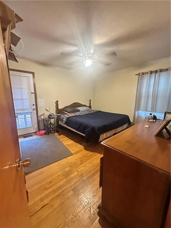 bedroom featuring hardwood / wood-style flooring and ceiling fan