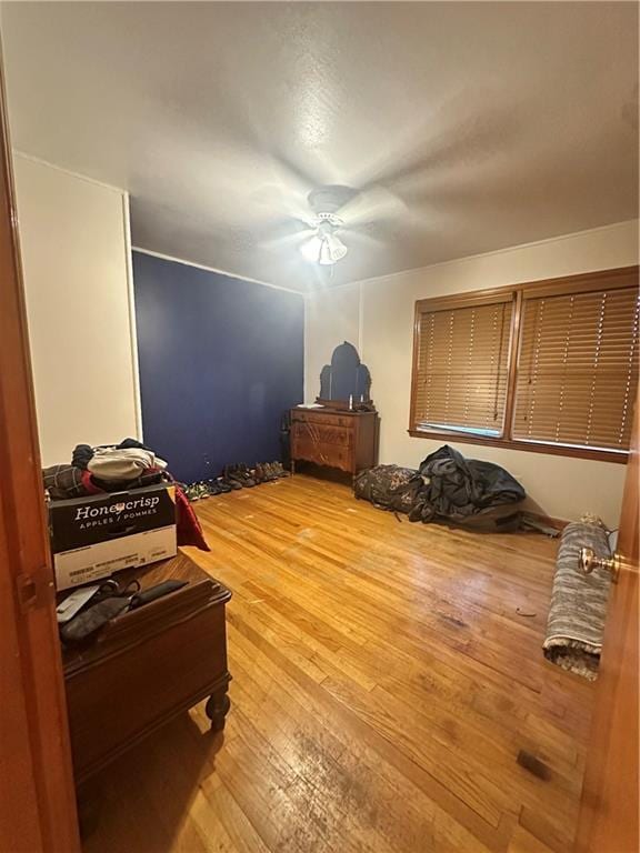 bedroom with ceiling fan and hardwood / wood-style floors