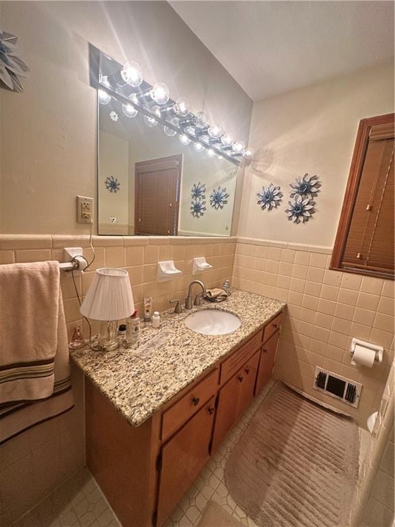 bathroom featuring tile walls, vanity, and tile patterned flooring