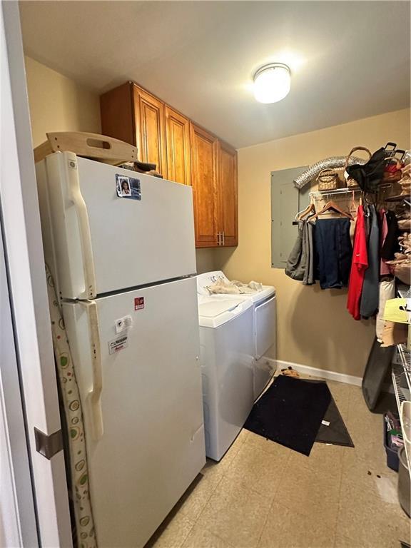 laundry room with washing machine and dryer and cabinets