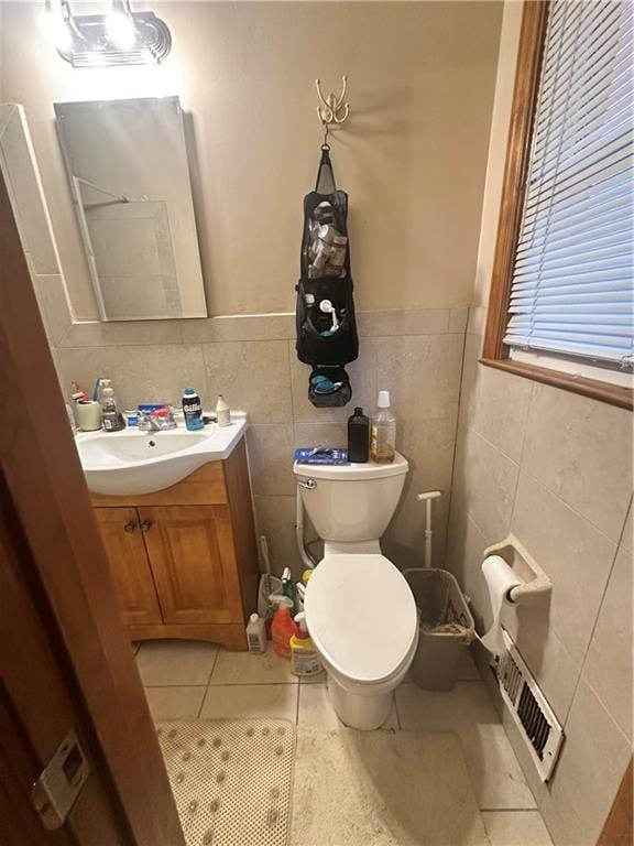 bathroom featuring toilet, vanity, and tile patterned flooring