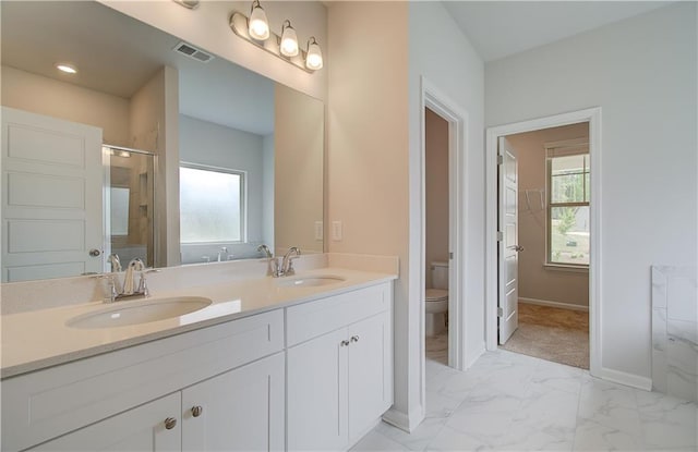 0 Cooper Cv E, Fayetteville, GA 30215 - bathroom featuring toilet, double vanity, baseboards, marble finish floors, and a shower with shower door