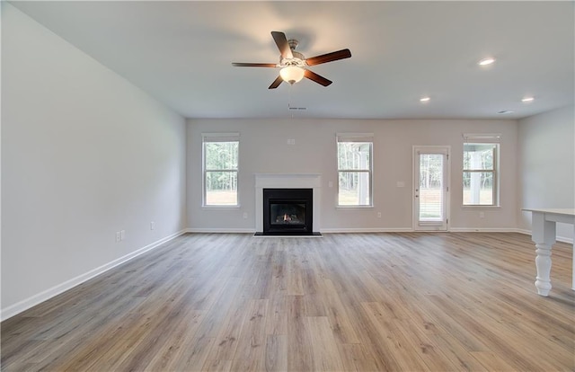 0 Cooper Cv E, Fayetteville, GA 30215 - unfurnished living room featuring a fireplace with flush hearth, ceiling fan, light wood-type flooring, baseboards, and recessed lighting