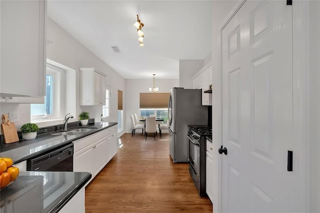 kitchen with pendant lighting, sink, white cabinetry, an inviting chandelier, and black appliances