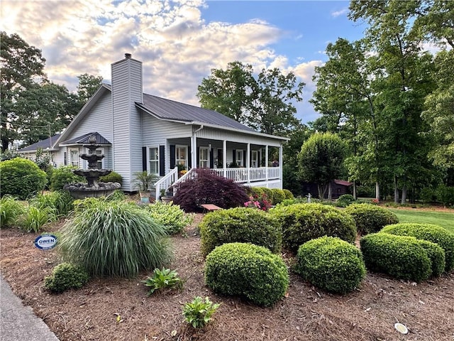 270 Owens Cir NE, Calhoun, GA 30701 - view of front of house with a chimney, metal roof, and a porch