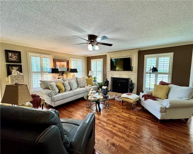 270 Owens Cir NE, Calhoun, GA 30701 - living room featuring crown molding, wood finished floors, a textured ceiling, a ceiling fan, and a fireplace