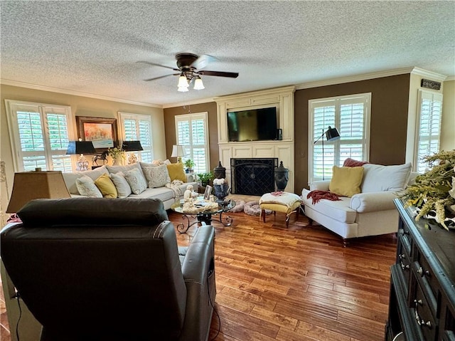 270 Owens Cir NE, Calhoun, GA 30701 - living room featuring crown molding, a ceiling fan, a textured ceiling, dark wood-style flooring, and healthy amount of natural light