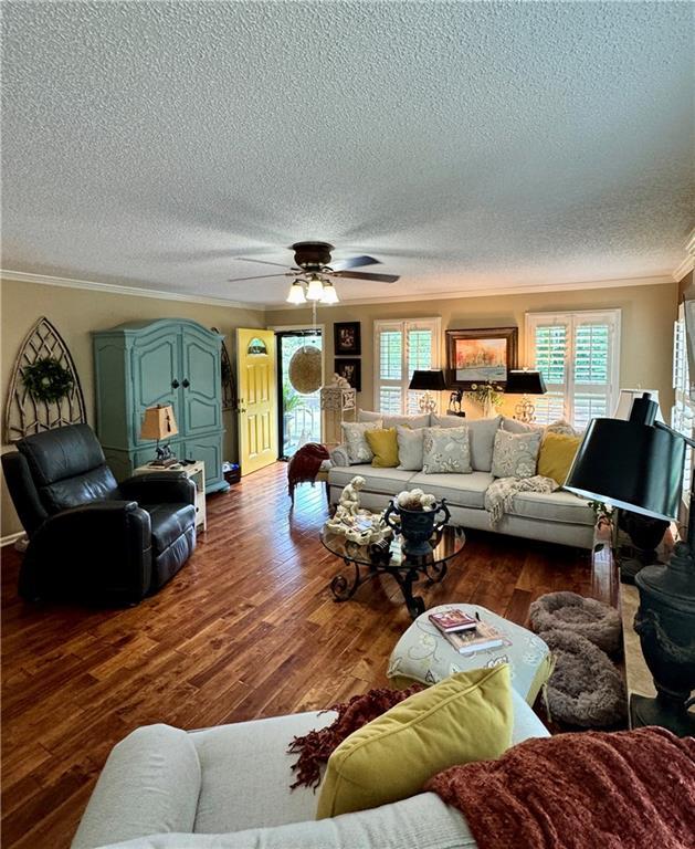 270 Owens Cir NE, Calhoun, GA 30701 - living area with ornamental molding, a textured ceiling, dark wood finished floors, and a ceiling fan