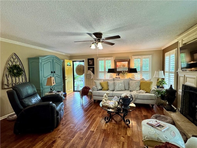 270 Owens Cir NE, Calhoun, GA 30701 - living room featuring dark wood-style flooring, crown molding, ceiling fan, a textured ceiling, and a fireplace with raised hearth