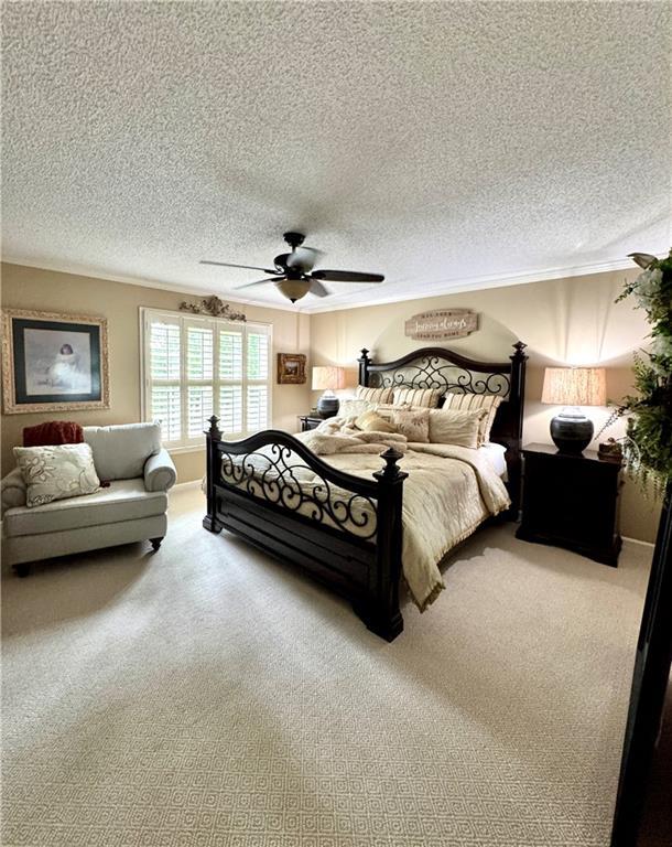 270 Owens Cir NE, Calhoun, GA 30701 - carpeted bedroom with a textured ceiling, a ceiling fan, and crown molding